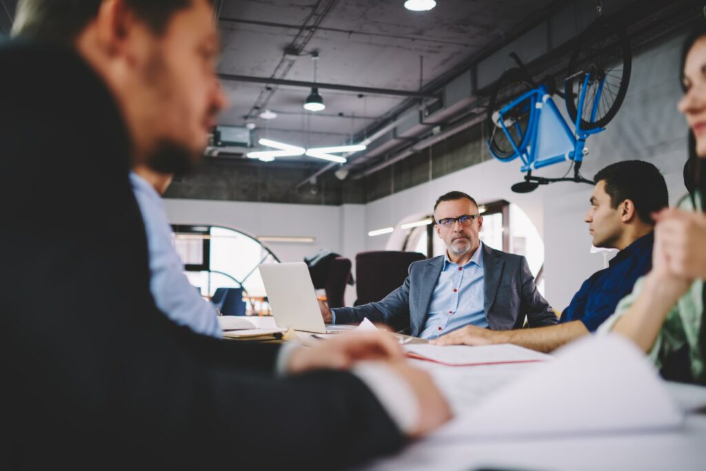 Experienced owners in formal wear talking about competition and entrepreneurship in entreprise firm